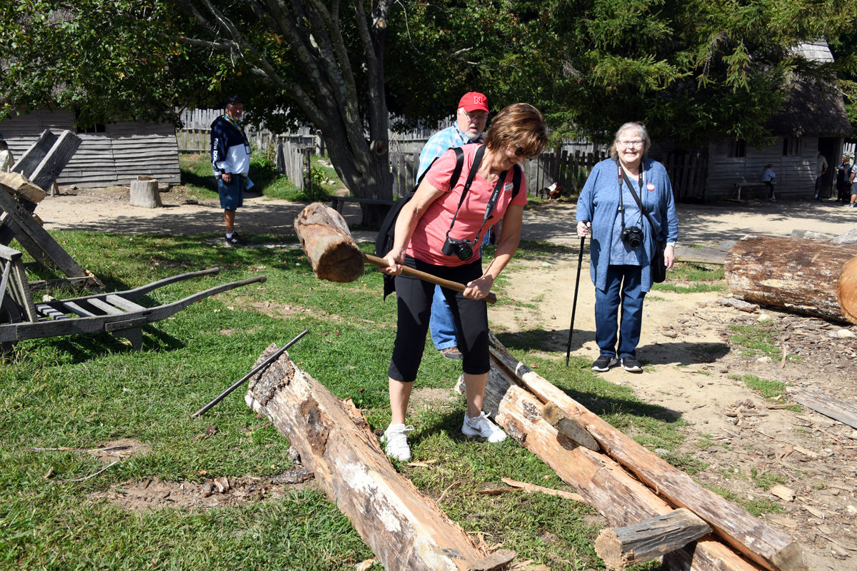 037 Connie Nickel tries her hand at splitting a log. Watching are Ron Nickel on far left, Karl Sherman and Bondel Friesen.jpg